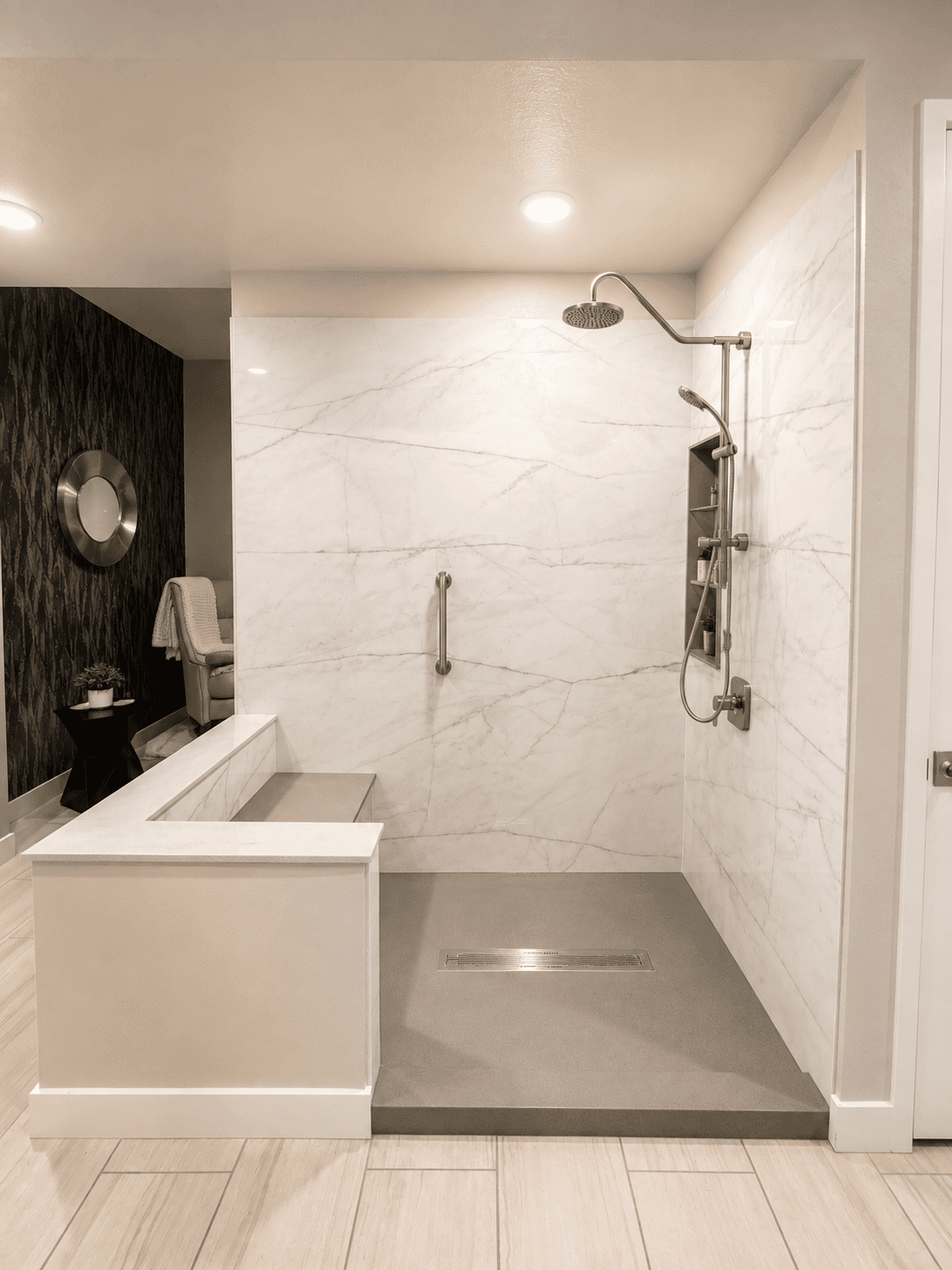 Modern luxury bathroom with walk-in shower featuring white marble tile walls, brushed nickel fixtures, rainfall showerhead, gray stone floor, and separate soaking tub with black accent wall